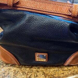 Dooney and Bourke,  hobo style, black and tan leather bag.